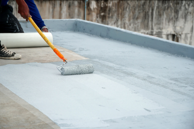 Professional waterproof flooring application with paint rollers in Qatar by Pedox Qatar